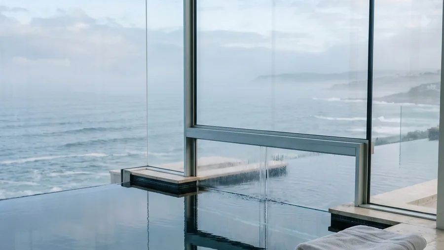 Illustrative image for Cliff House Hotel: A glass fronted house in an Irish cliff, a starred kitchen and the sea in every window